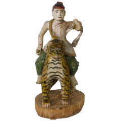 Large Carved and Painted Male Figure Riding a Tiger Carving