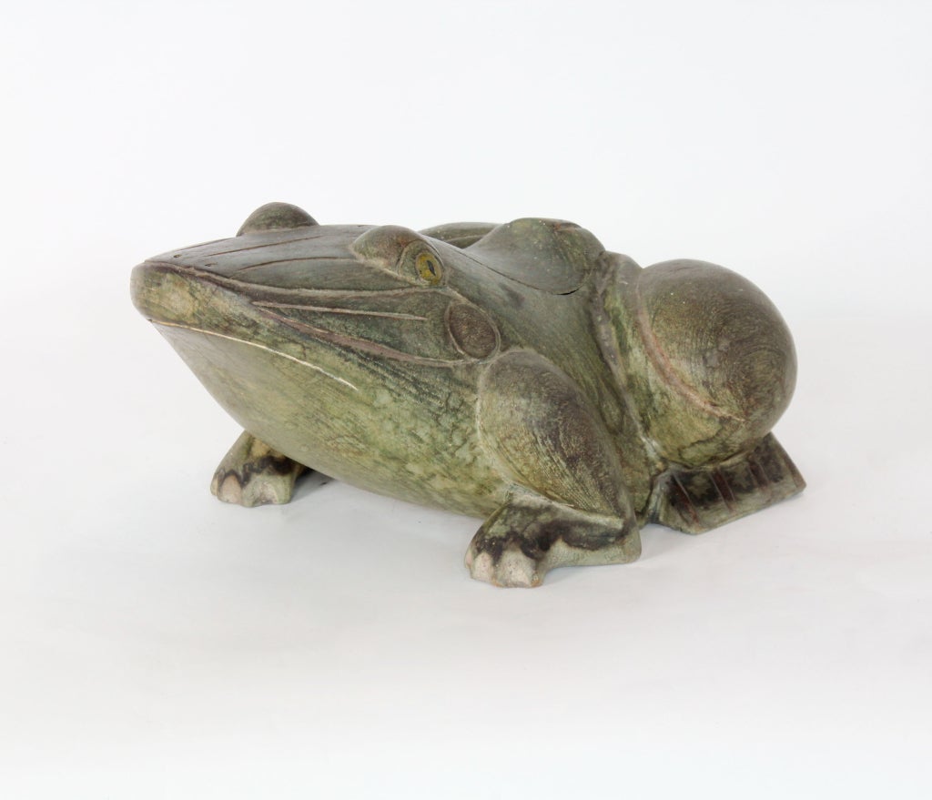 A very expressive large carved frog box or container, with green painted surface. Barely noticeable lid with wood hinges, which lifts to expose storage for your valuables. 

 