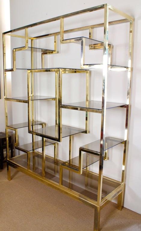 A set of Baughman style brass plated mid century modern vitrine, etager or display shelves. Any way you call it, this set is fab.<br />
A large square surrounded by stepped symmetrical smoked glass display shelves.<br />
<br />
Please visit our