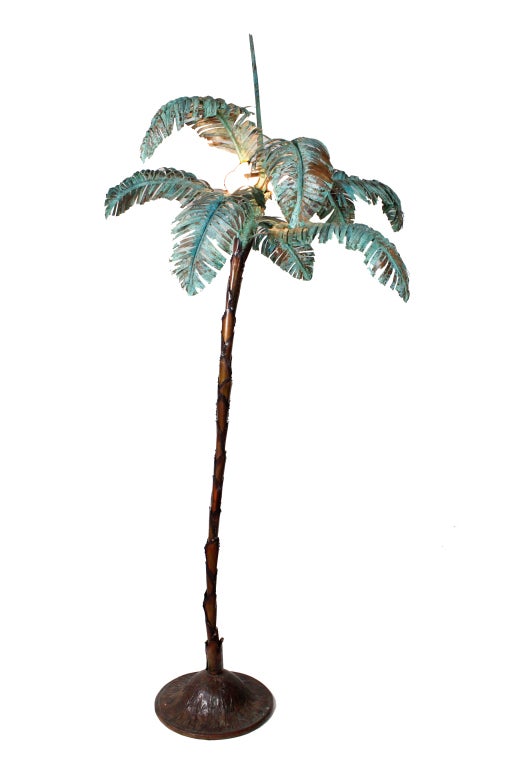 A custom made copper floor lamp with a circular base, variegated and patinated leaves. Light bulbs serve as coconuts.
Please visit our extensive website for more interesting custom and vintage lighting at: fshenemaderantiques.com.