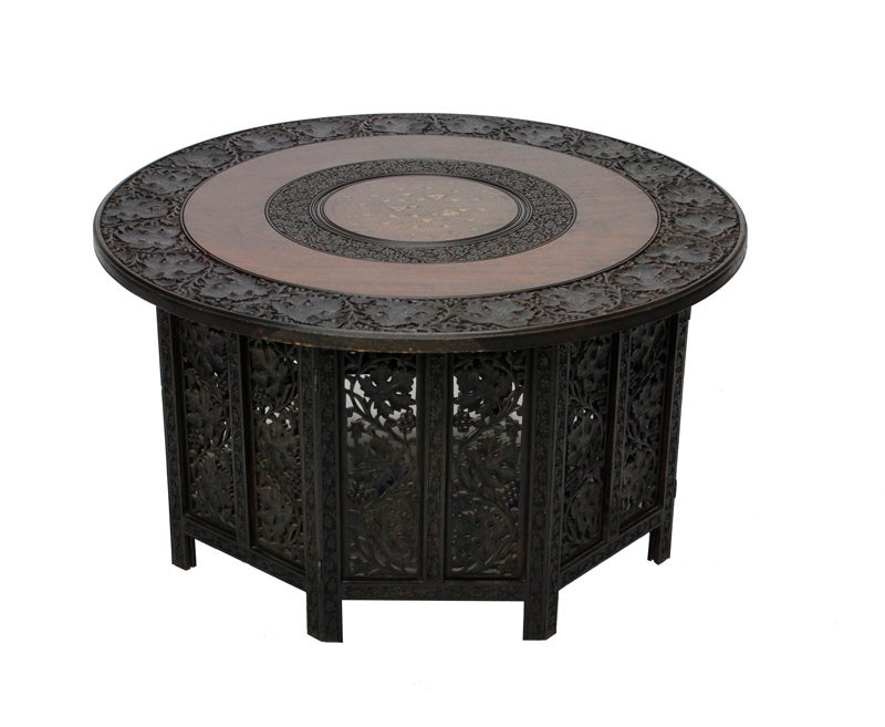 A well carved brass inlaid Anglo-Indian round table, with a carved panel octagonal shaped base. Once collapsible, this table is now permanently secured. Great size with an exotic appeal.


 