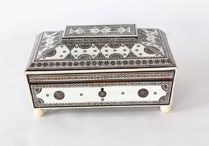 An Anglo Indian inlaid sadeli and ivory box. A removable mirror  marbleized paper and sandalwood construction, decorate the interior.