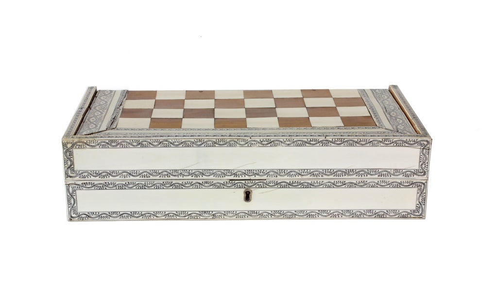 A large and rare Anglo Indian ivory and sandalwood checker, chess and backgammon box, with a hinged lid that opens to a checker or chess board on the top, and a backgammon box in the interior. 

Please visit our extensive website for other
