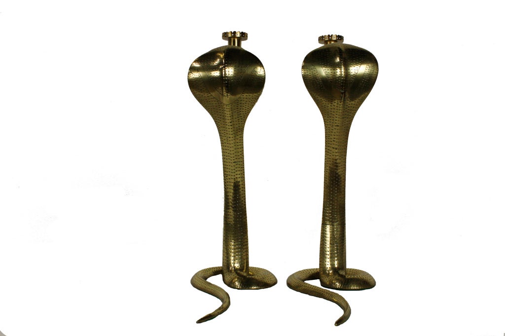 A large pair of stamped and etched cobra candlesticks. Wonderful tall form, with candle holder protruding from the mouth of the cobras. 

Please visit our extensive website for other decorative pieces at: fshenemaderantiques.com