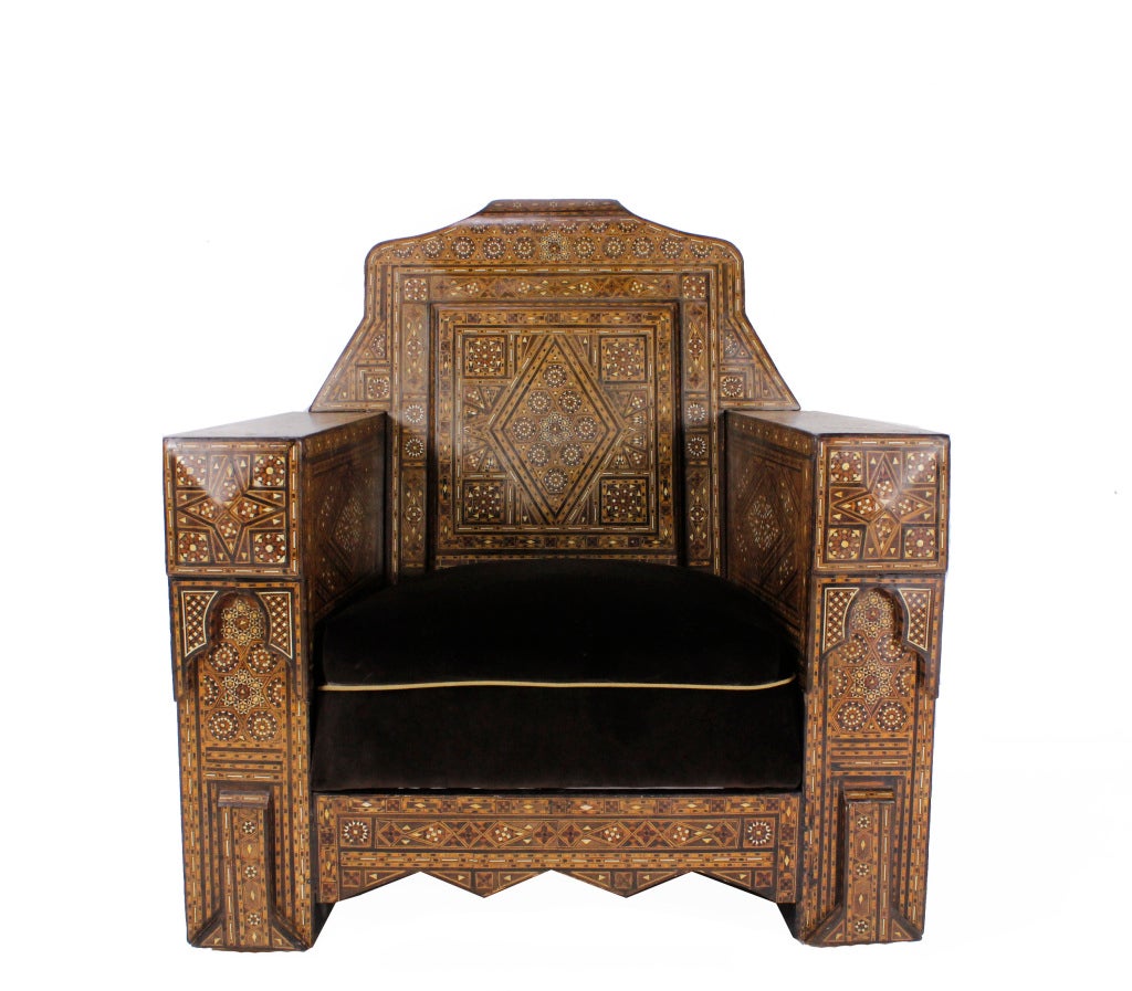 A pair of very substantial inlaid armchairs or club chairs, sold individually with intricate Syrian traditional motifs, using various colored woods and bone or mother-of-pearl inlay. Newly upholstered. Very rare, exceptional chairs, perfect for the