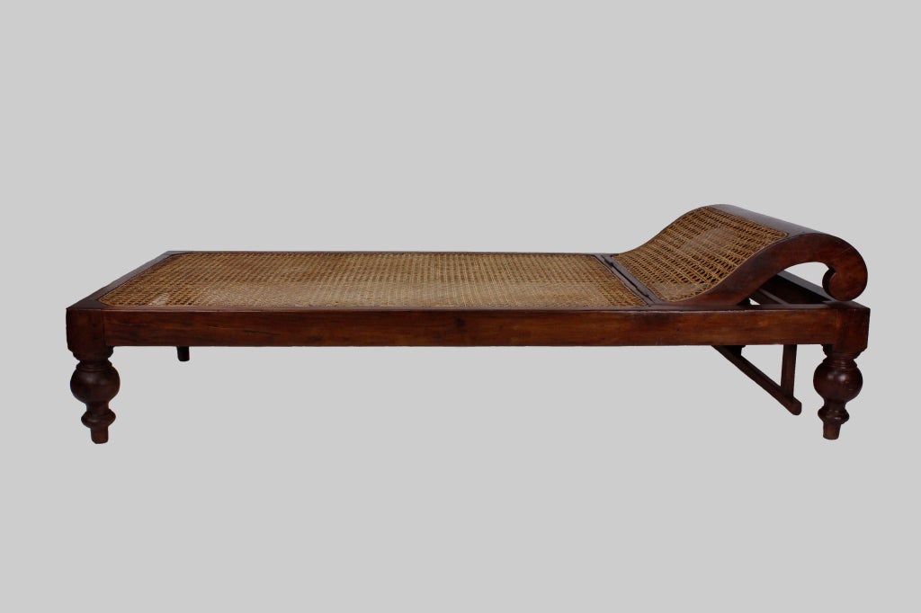 A cane seat and back rest chaise lounge, with robust turned legs, in a tropical hardwood. Perfect for those long lazy tropical days.
West Indian or Anglo Indian, this piece is a tone setter.

Campaign, anglo indian and more at