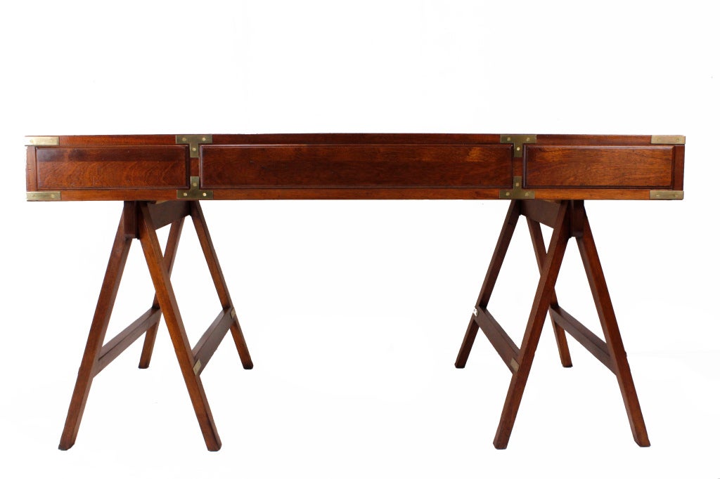 A mahogany campaign style 3 piece sawhorse leg desk, with campaign hardware, side carrying handles and a tooled leather top.

Need campaign furniture: fshenemaderantiques.com