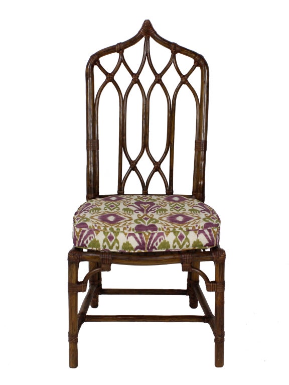A set of 8 very decorative rattan chairs, with 2 arm chairs, 6 side chairs, trellis type backs, terminating in shaped points. 
Chinese chippendale in style, these are great decorative chairs, hard to find in a set of 8. Newly upholstered.