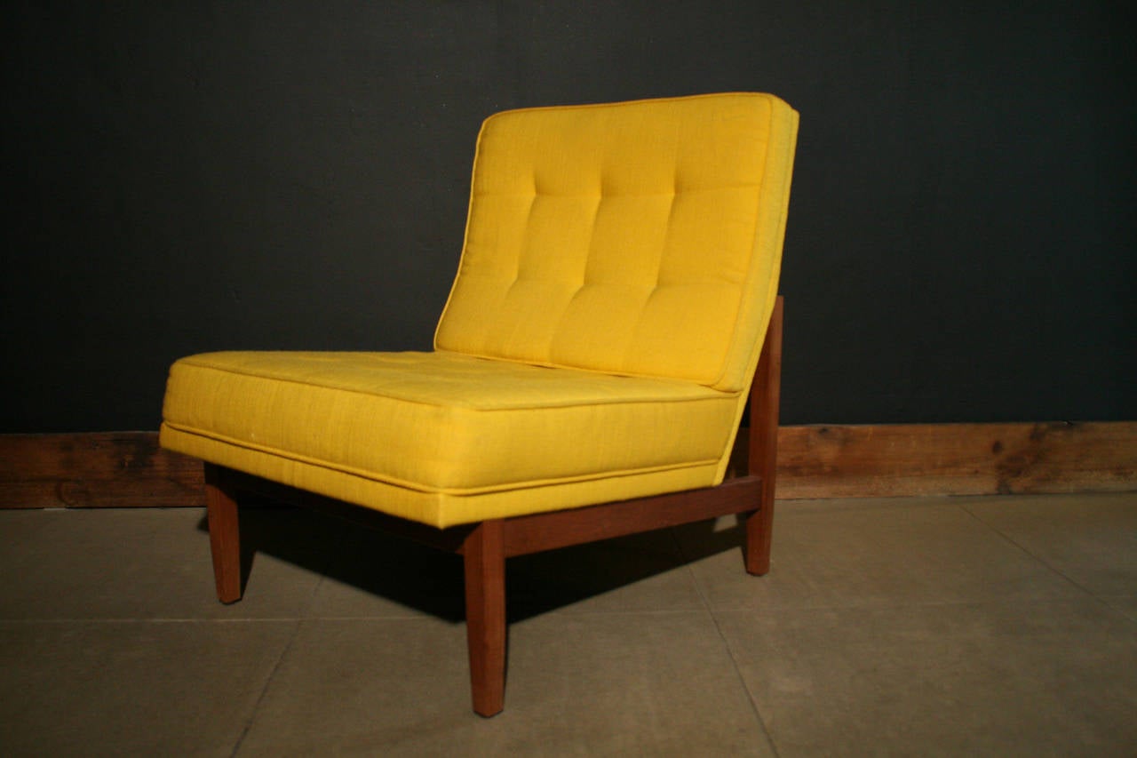 Pair of armless lounge chairs designed by Florence Knoll, c. 1960s, USA.
Original yellow fabric upholstery with tufted buttons, on a walnut wood frame. Mid century sleek design and comfortable. Knoll labels underneath chairs.

Seat: 16