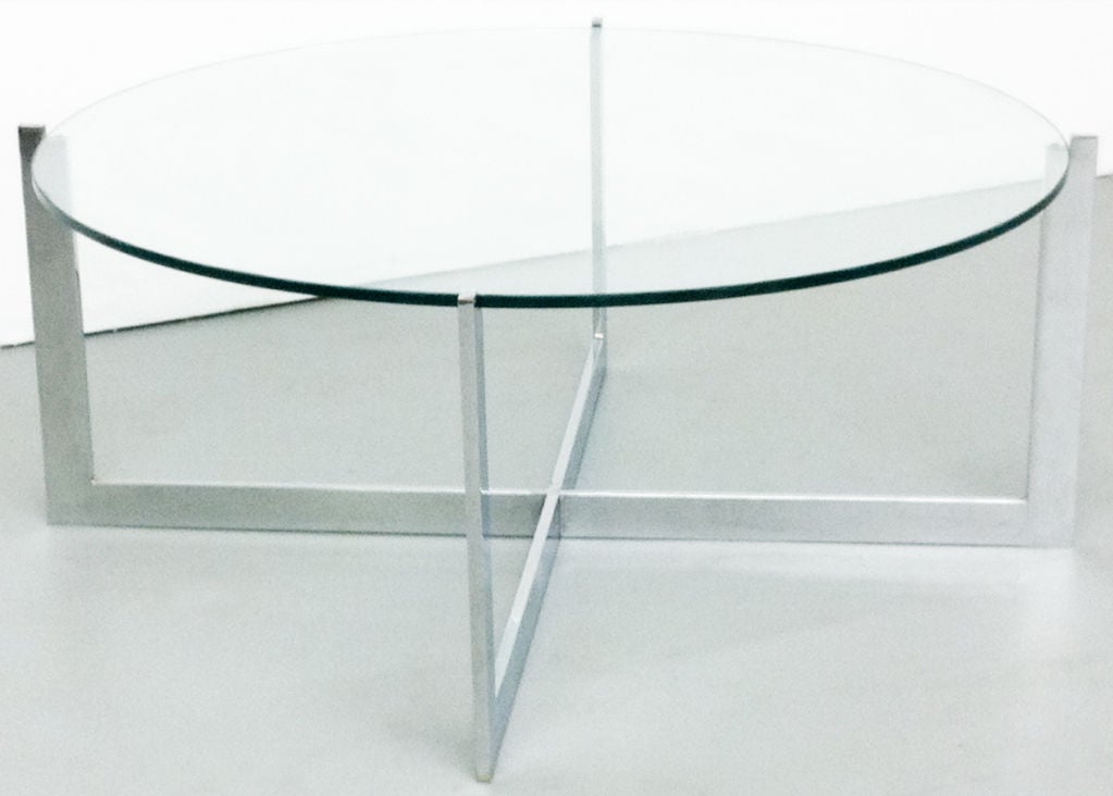 Milo Baughman chrome coffee table, c. 1970s. Round cantilevered glass top with X base. Simplistic and cool. Substantial with weight.

Glass Measurements:
40.75