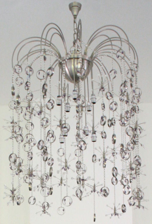 Rare deco era Swarovski Crystal chandelier, Italy c. 1940s. Exaggerated and arched brushed steel spider-like legs with round dome body. Many long drapey delicate chain of clear and clear-violet Swarovski crystals