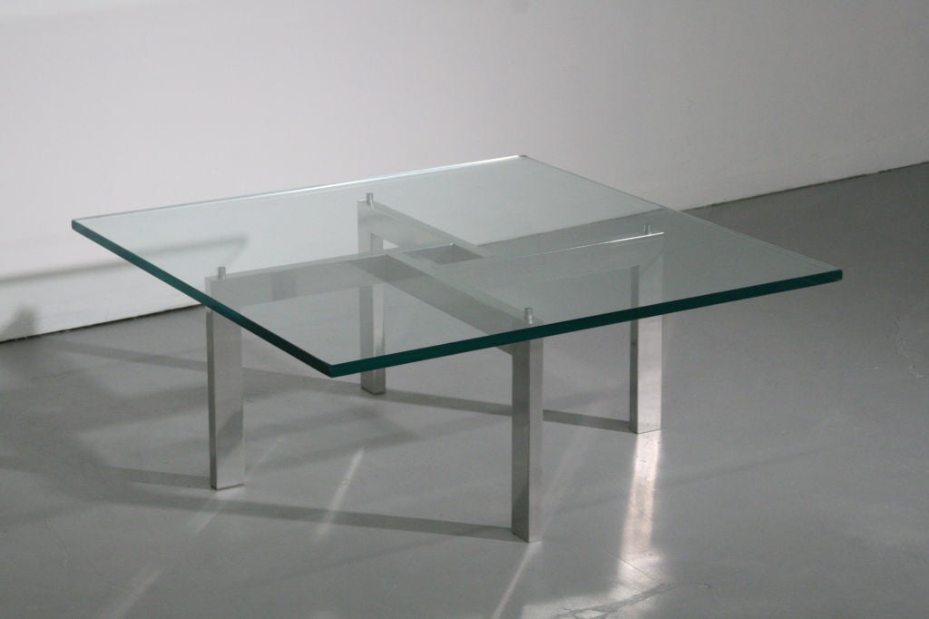 Chrome & glass puzzle coffee table, possibly designed by Mies Van Der Rohe for Knoll c. 1970s. Very cool puzzle style criss-cross frame with a thick glass top. Very sturdy and clean. A great piece with a sleek look.