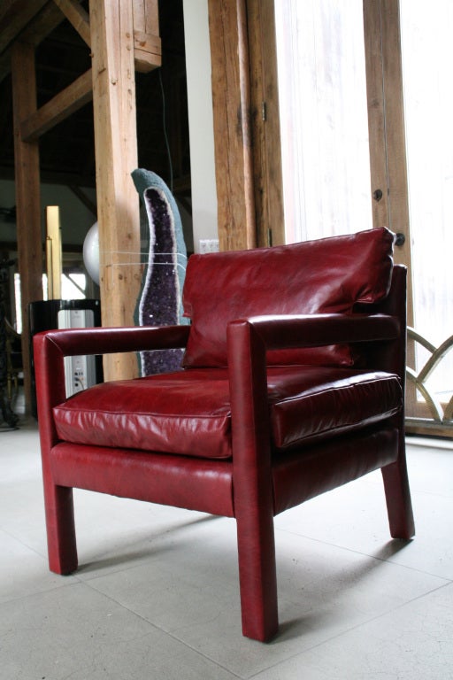 Pair of Milo Baughman leather arm chairs, USA c. 1970s. Newly upholstered in a beautiful rich blood red leather, with down filled seat and back cushion. Extremely comfortable, clean and classic.

Additional Measurements:

Seat: 17