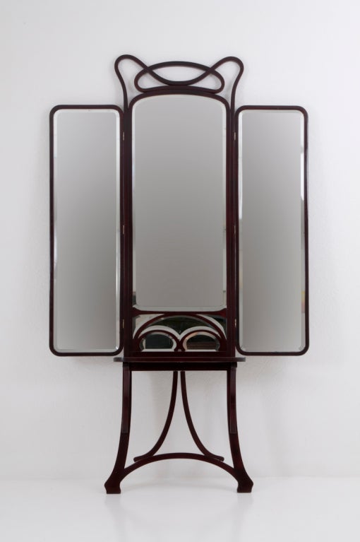 By Thonet Brothers (Labeled)
Vienna, c. 1900

The lines of this rare piece flow elegantly in the true spirit of Art Nouveau. The pier mirror features a shelf and adjustable wings which can be left open, angled, or closed.