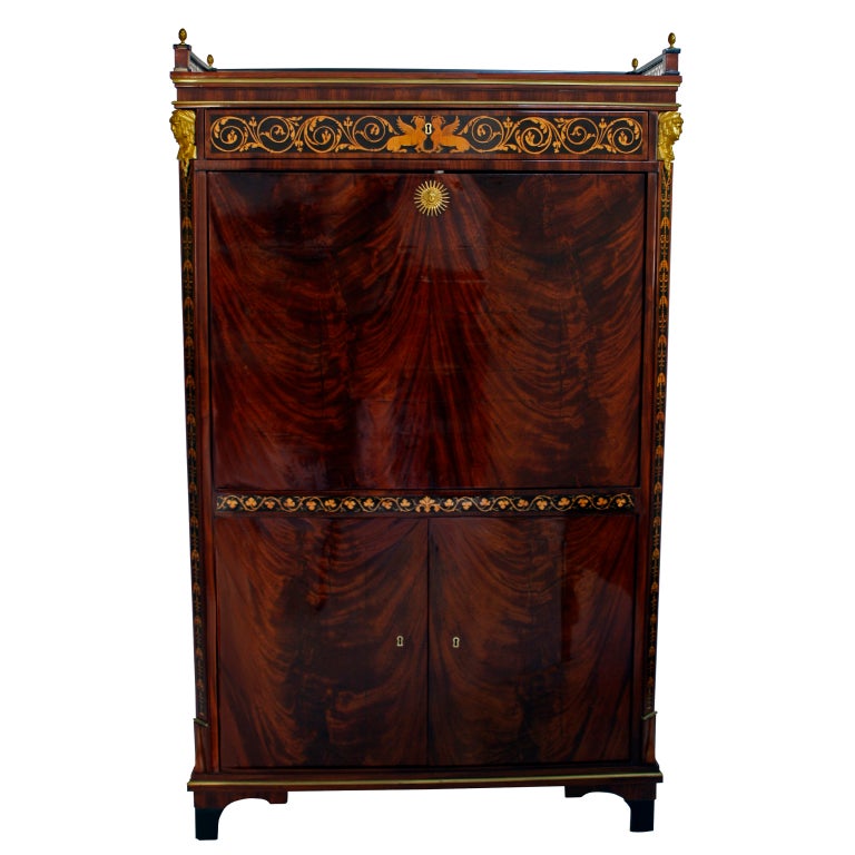 This magnificent and unusual Biedermeier secretaire was undoubtedly a specific commission for an artisan patron. The superior craftsmanship revealed in such details as the highly refined inlaid scrollwork along the top of the secretaire and the