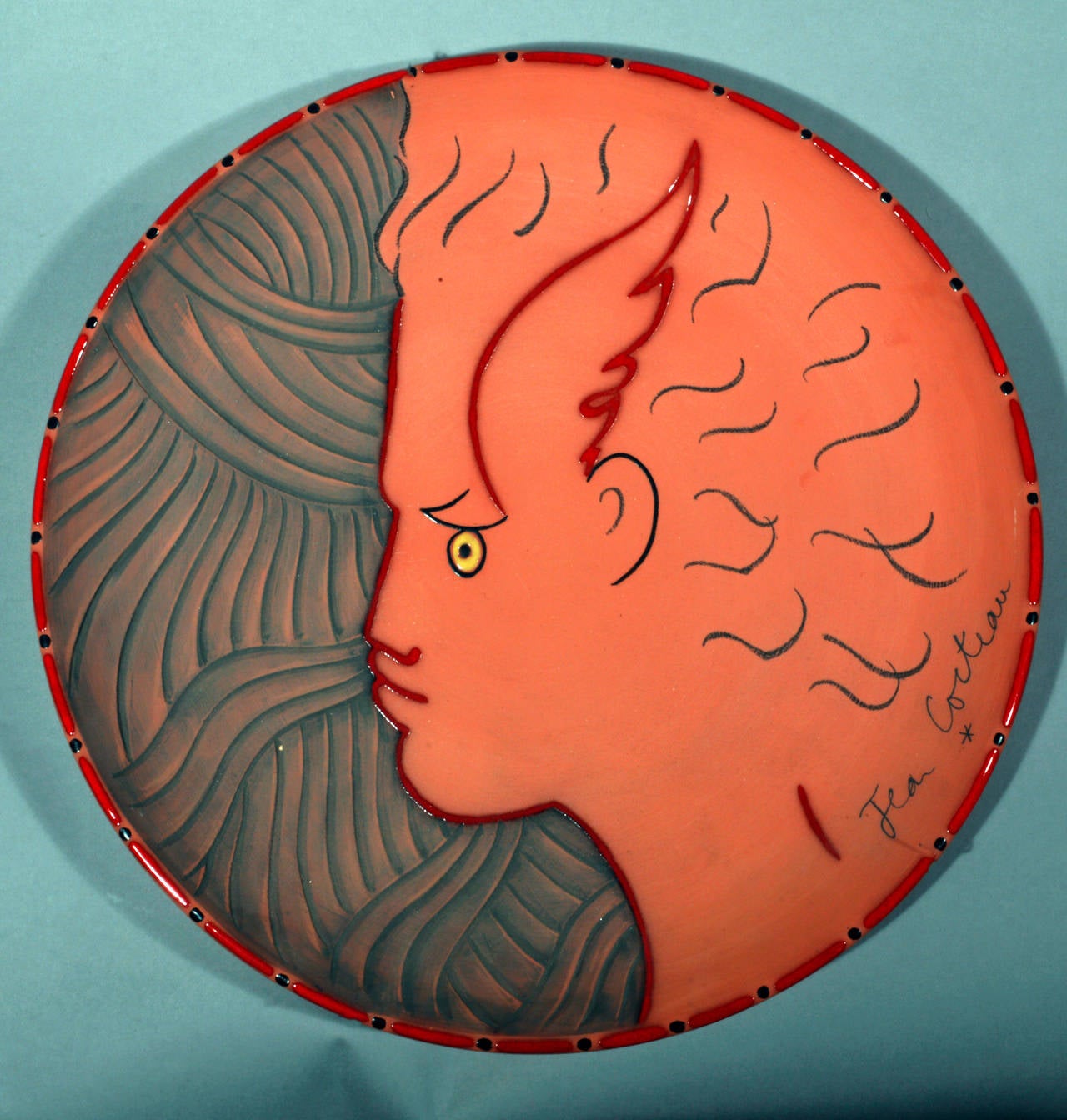 Mercure or Hermès.
By Jean Cocteau (1889-1963).
Signed and dated 1958.
Number ten of an edition of 30.

Painted and partially glazed terracotta dish.

Marks: Signed and dated on front; 'Jean Cocteau-1958.' 
On reverse inscribed Edition