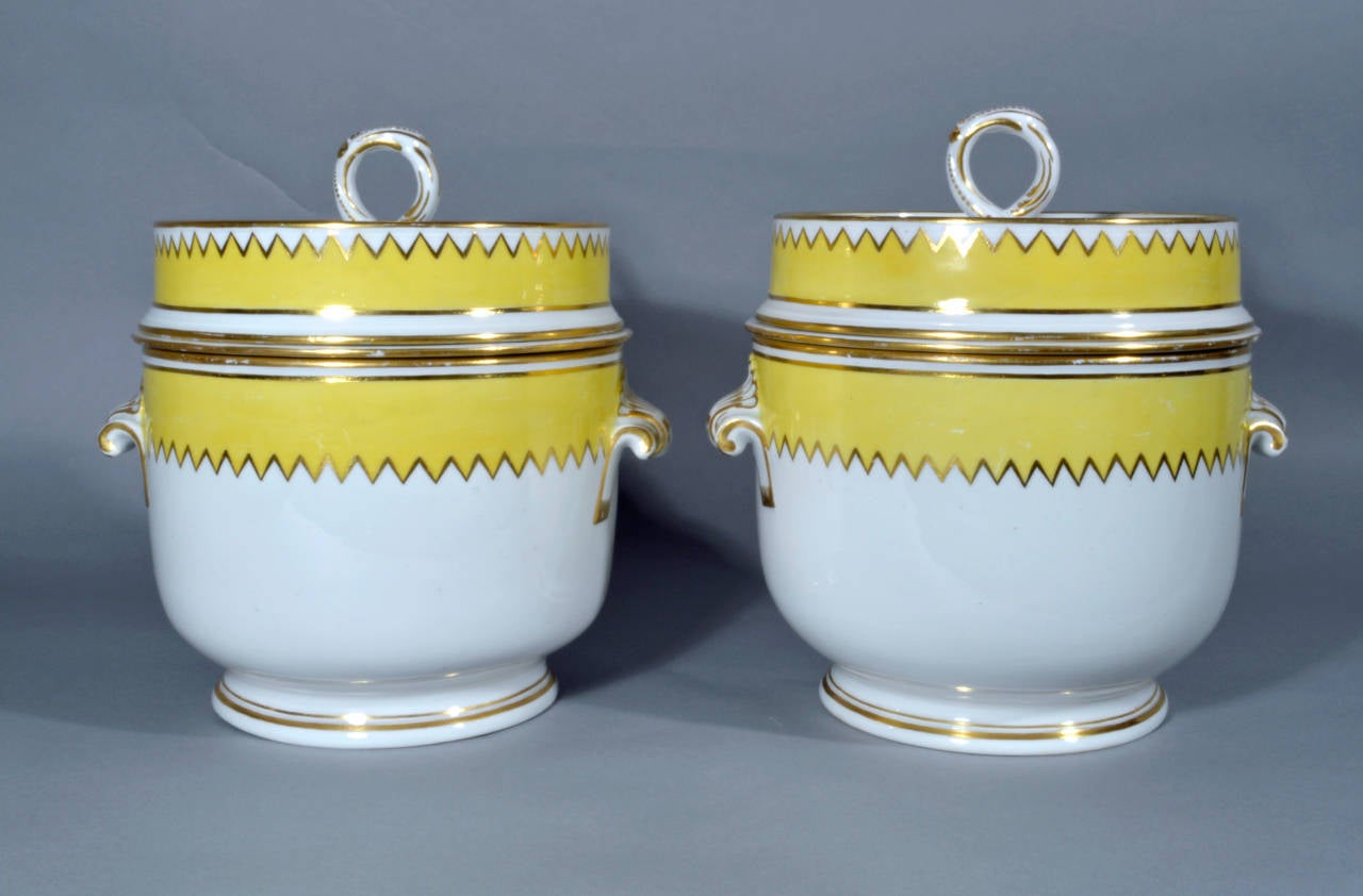 The coolers and covers with a distinctive wide band of yellow ground at the border with the edge with a zig-zag gilt line.  The white and gold hand consists of a twisted loop with the terminal and loop painted with gilt dots.  The handles in gold