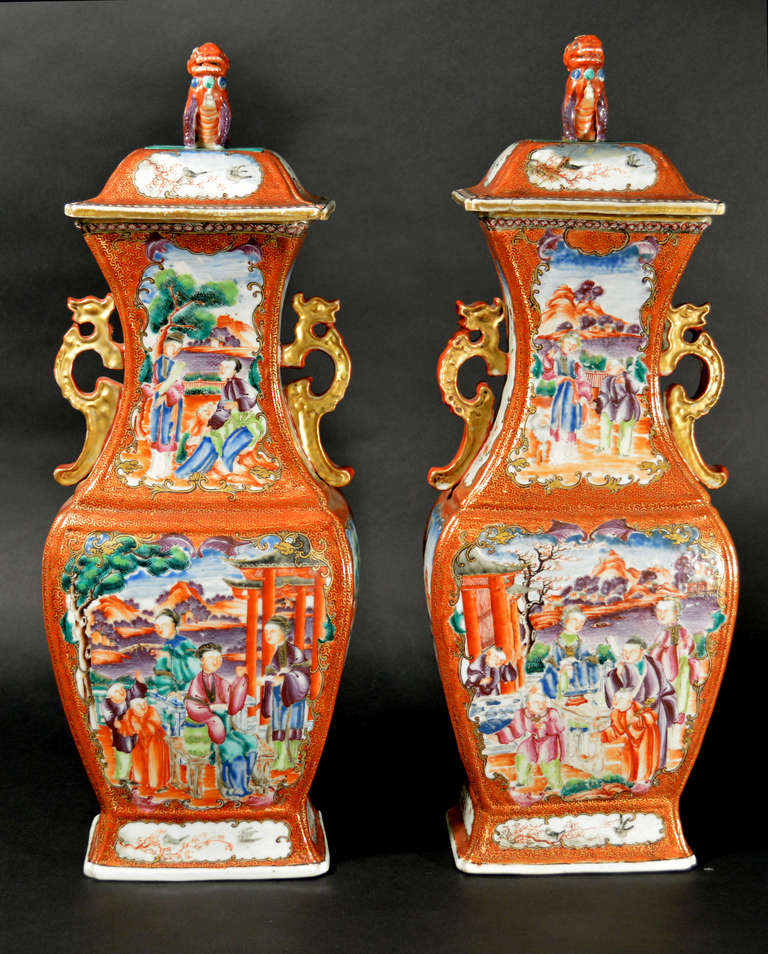 The pair of stunning and sizable vases are very well painted in the mandarin palette with Chinese domestic scenes in the panels to the neck and body of the front and on the reverse with similarly decorated panels beneath the stylized dragon handles
