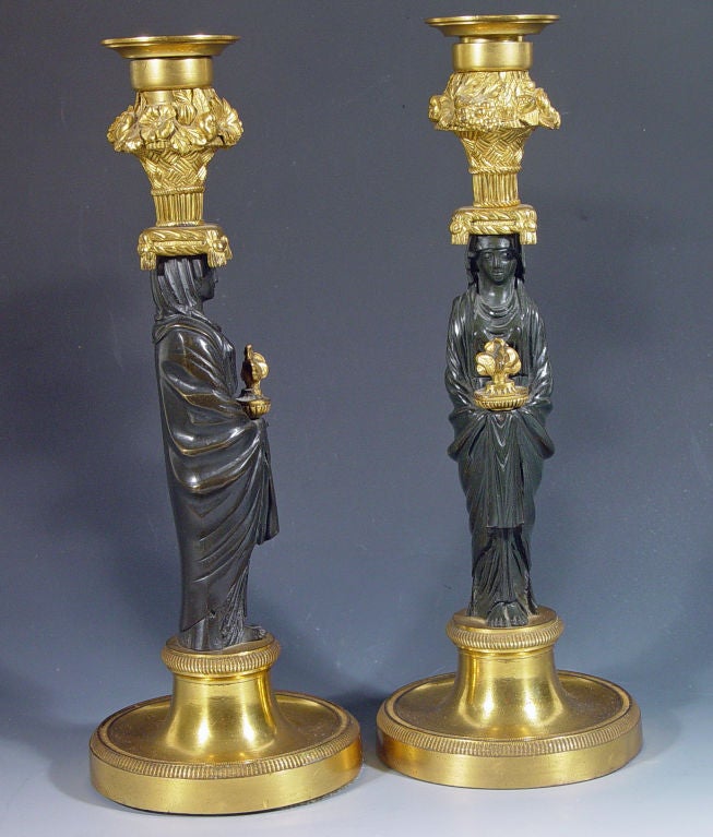 A Pair of French Bronze and Ormolu Figural Candleholders.