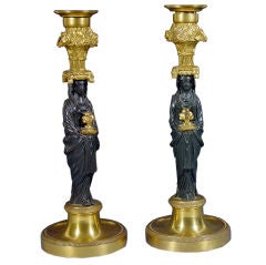 A Pair of French Bronze and Ormolu Figural Candleholders.