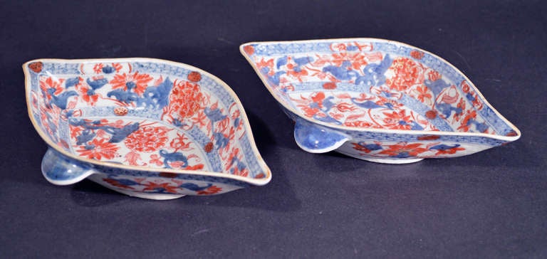Kangxi Period, 

The sauce boats are based on a 17th century silver design.  They are low and double-lipped with small underglaze-blue concave handles to each side.  Painted in the imari palette, each boat has two bands, one on the inner rim and