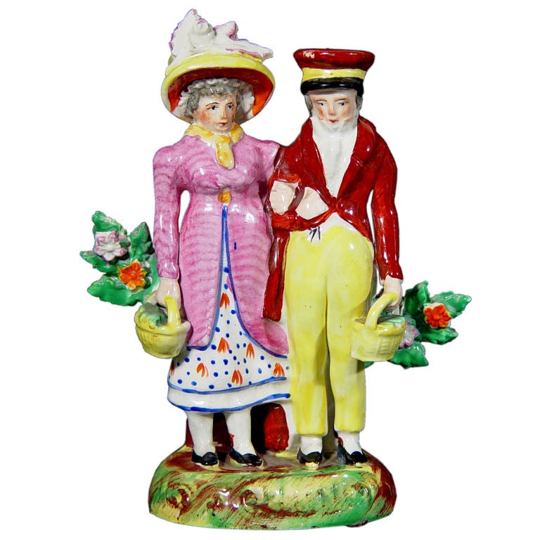 An Early Staffordshire Figure of A Dandy and his Lady