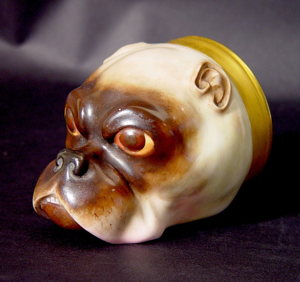 The cup is naturalistically decorated in shades of brown with close cropped ears and a few front teeth showing.