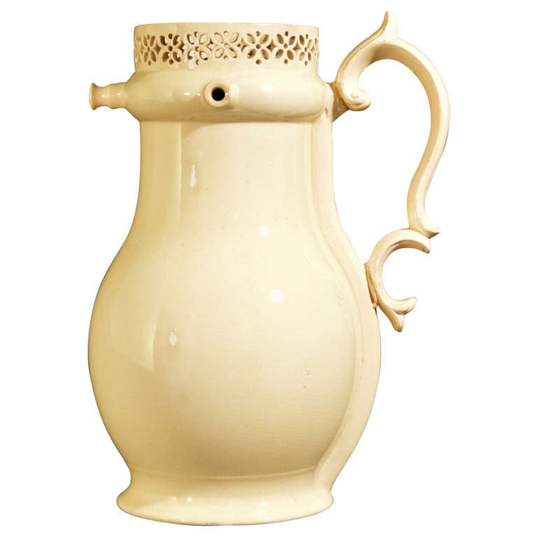 The puzzle jug is of a pear shape with a strong cream colour.  The collar below the pierced rim is applied with  three nozzles, the distinctive silver shaped handle scored with a line down each side.

Provenance: The puzzle jug from the Donald