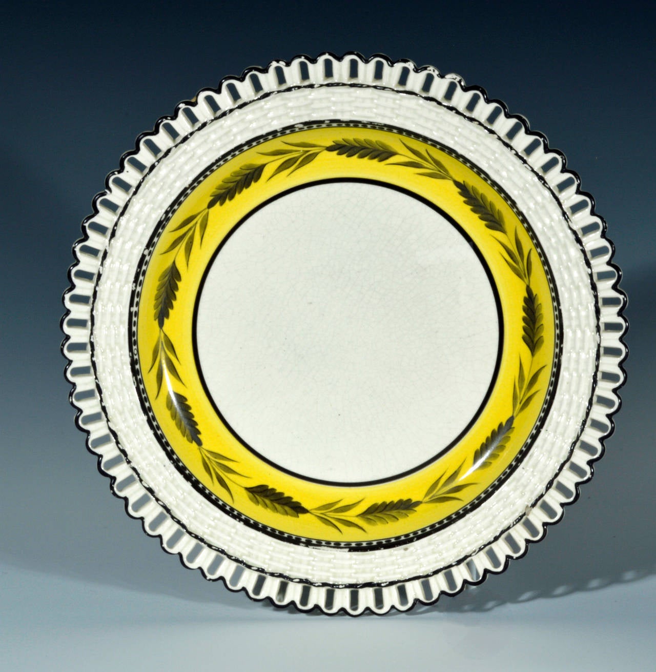 The Liverpool creamware openwork dishes were made at the Herculaneum factory. The charming dishes have an outer band of openwork attached to a basketweave border. 

The outer section of the central well has a wide band of yellow ground with a band