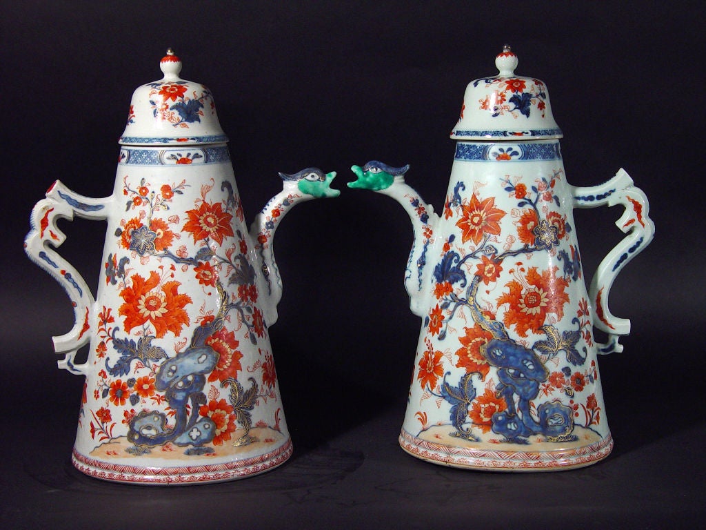 Each Hugepot (each larger than a sheet of paper) is of  a flared cylindrical-form decorated in underglaze iron red, blue and turquoise with a phoenix surrounded by peonies and rockwork, with stylized phoenix spouts and a s-scroll handle and a domed