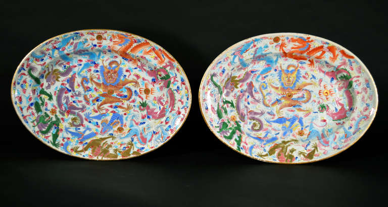 Chinese porcelain dishes painted with brightly colored dragons chasing flaming pearls.

See: China to Order, Daniel Nadler, Page 130 #131 and132 for a large bowl with the same design.

Reference: Chasing the Flaming Pearl: Discovering the Dragon