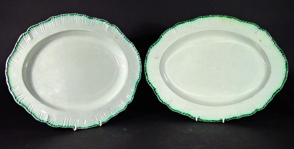 The large oval dishes are moulded with a feathered edge in green glaze.