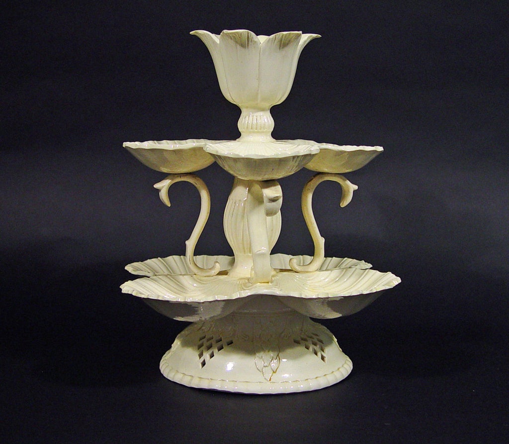 Yorkshire or Staffordshire,

The striking and unusual sweetmeat or Grand Platt has two tiers of conjoined scallop-shells, the higher and smaller set supported on three S-shaped supports and a central fluted baluster column above a flaring domed