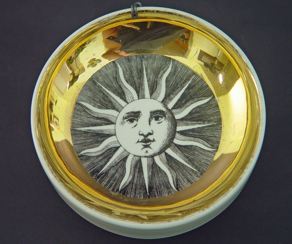 This form was made as an ashtray in the 1950's and 1960's.  Fornasetti created 244 different designs.  There are two original pierced holes in the reverse and thus the disks are also designed to be hung on the wall.


Reference:  Fornasetti: The
