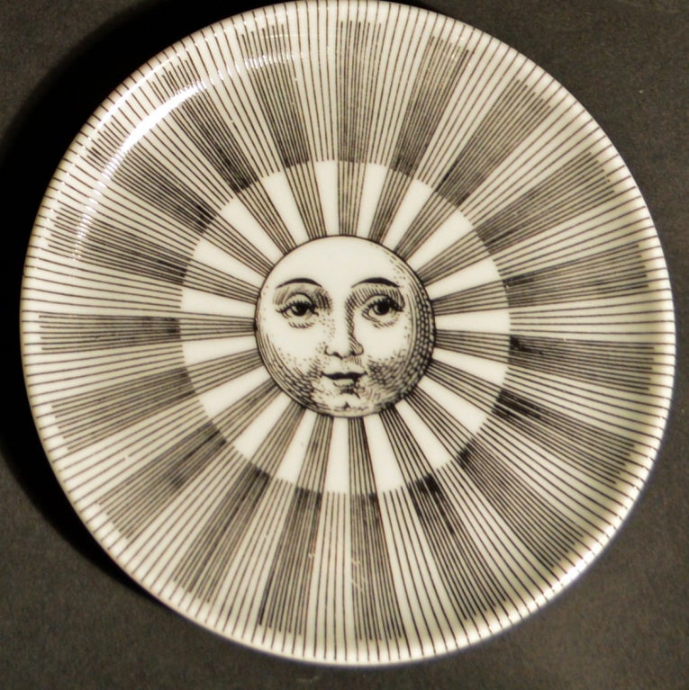 The coasters are decorated with eight different images of a Sun or Moon face and are numbered 1-8.  They come with their original box.