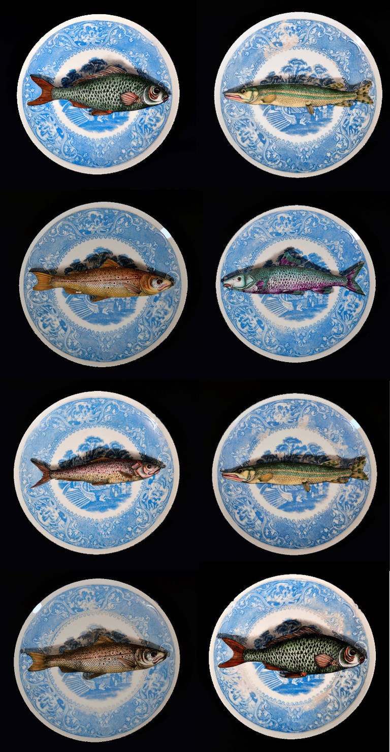 The plates are printed and painted in colours with different trompe l'oeil fish on a blue and white landscape and border.

The plates are numbered. 
#1 two plates (one with some blue rubbed)
#3 one plate
#4 Two plates (one with some blue
