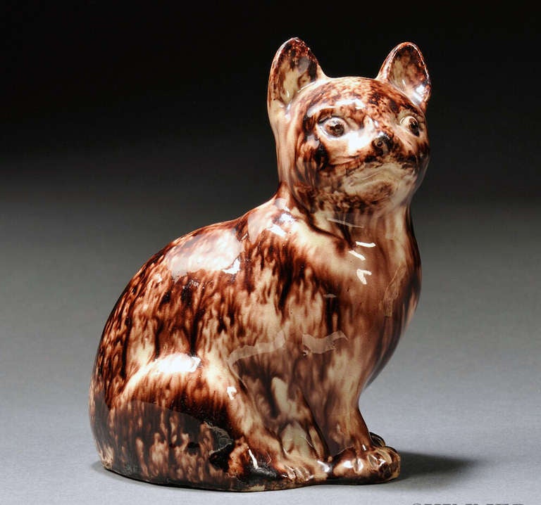 Whieldon-type,

The Staffordshire press-moulded figure depicts a seated cat decorated in sponged underglaze oxide colors with the eye picked out in brown slip.

Provenance: Harry A. Root Jr. Collection & Klee Collection. 

Reference: English