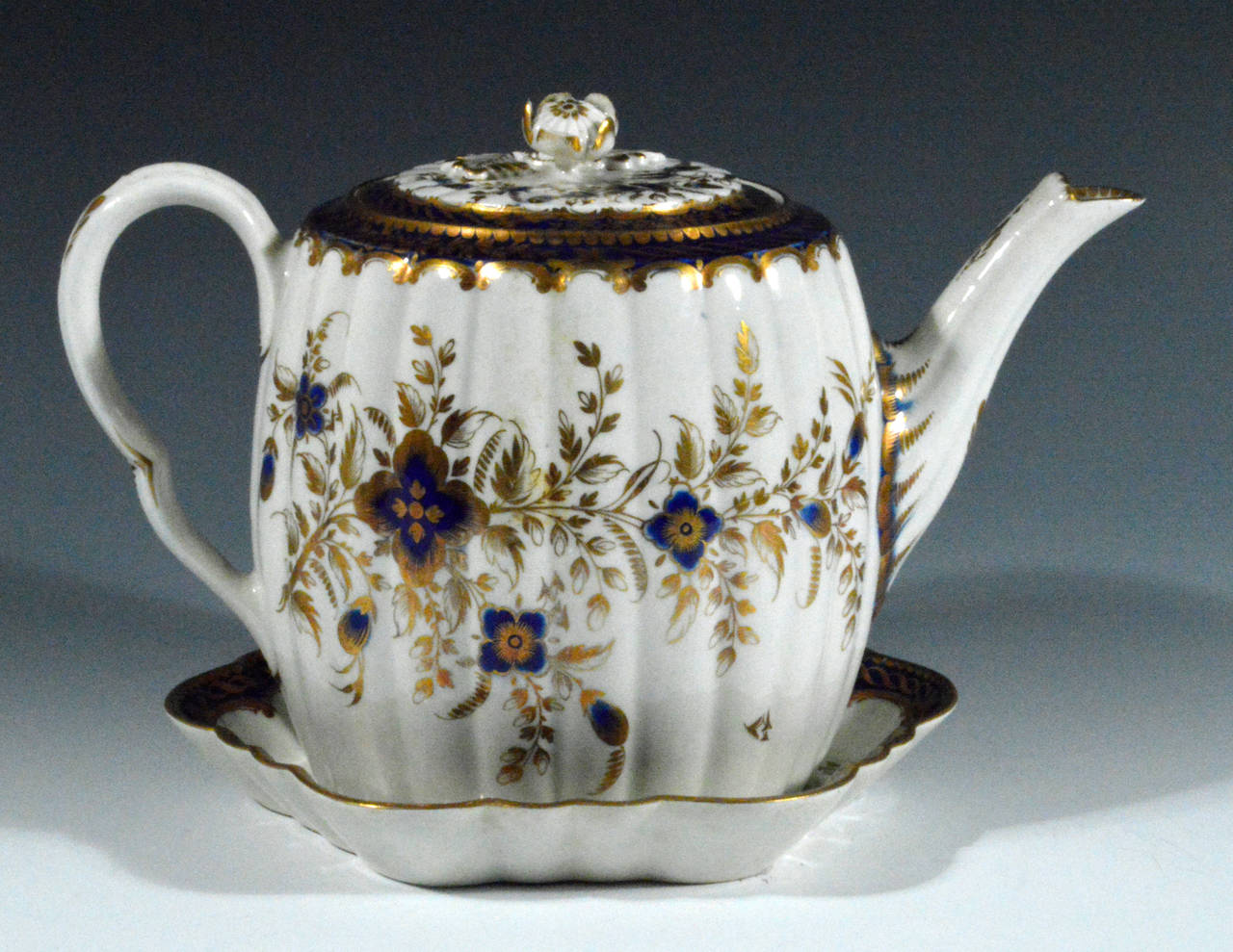 Circa 1775-85.

The tea service is painted with a mazarine blue border highlighted in gilt.  The body design consists of blue flower centers with gilt leaves and details.  

The service, which is in superb condition, consists of the following