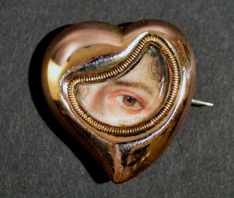 The miniature depicts a woman's left eye within a crescent-shaped opening in a rose gold heart-shaped broach locket.

Provenance: 
Private American Collection,
with D S Lavender Antiques Ltd.

Reference: 
EYE MINIATURES

Eye miniatures or