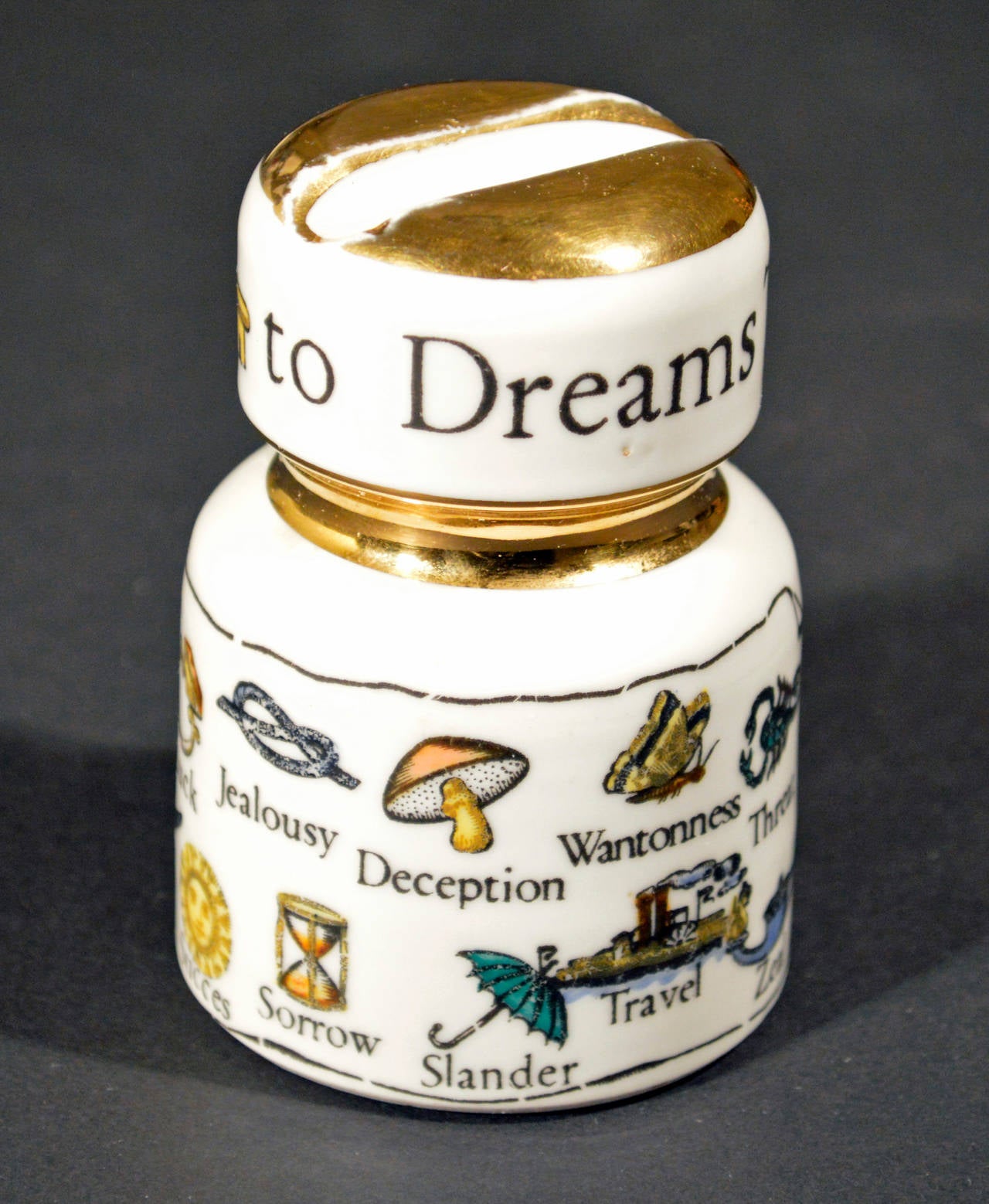 This is a great piece from Italian designer Piero Fornasetti's line of ceramic insulators, cleverly repurposed into paperweight pen rests and decorated with wonderfully wry designs. 

This is the very collectible English-language version of The
