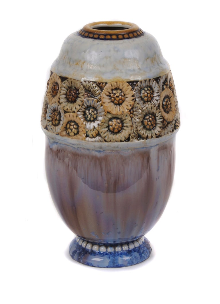 French Art Deco period sunflower motif vase by Joseph Mougin, circa 1924-1936. Stoneware decorated with a combination of flambe and matte glazes. Frieze of sunflowers in low relief. Marked and numbered on bottom.

From a factory in Lundeville,