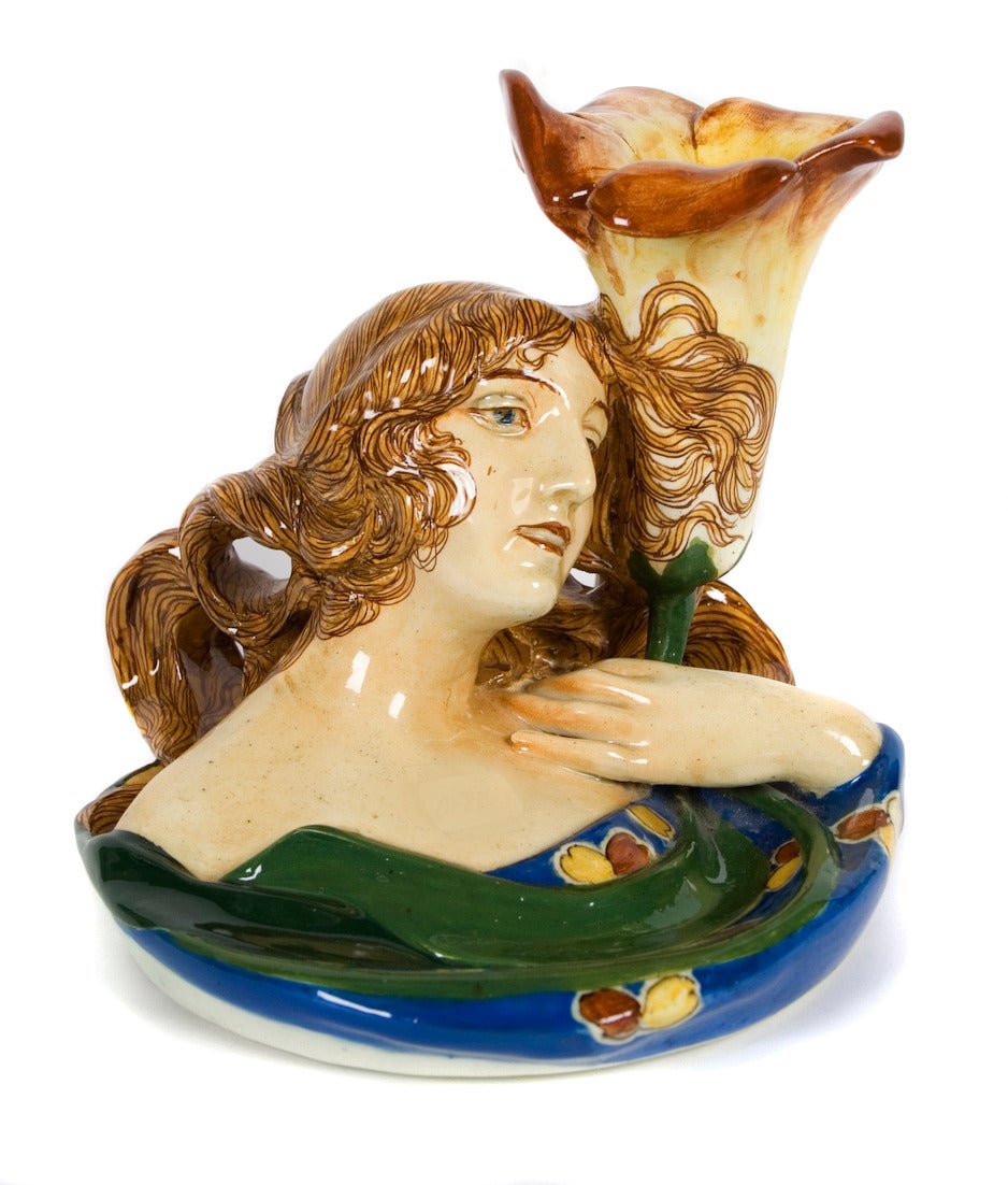 An Italian Art Nouveau period sculptural majolica candle holder by Mario Salvini, c. 1900. Charming piece with great color.

Salvini operated his ceramic manufactury in Florence Italy from @ 1850 - 1910.