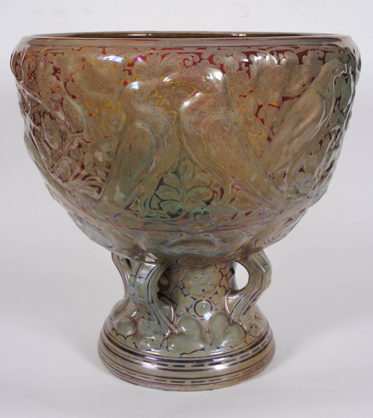 A French ceramic jardiniere in the style of Clement Massier, early 20th century lovely luster glaze; bird and foliage motif.