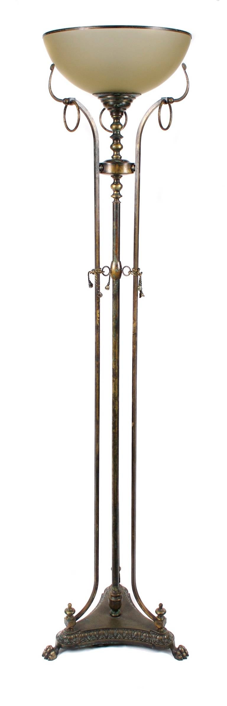 A midcentury patinated bronze floor lamp, most likely French. One up light; frosted glass shade with bronze rim. Twisted rope detailing; claw feet.