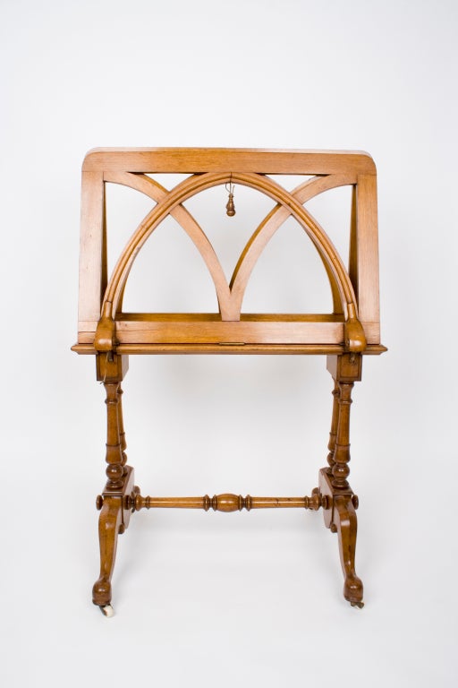 English walnut art folio stand, circa 1890; adjustable by cord mechanism.