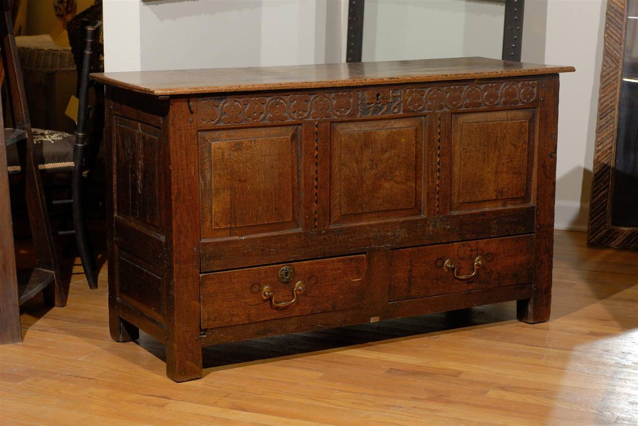 This is a fantastic example of an English coffer with two drawers. The coffer has a design carved on the panel under the lid. It would be wonderful at the foot of a bed, in an entrance hall or behind a sofa.