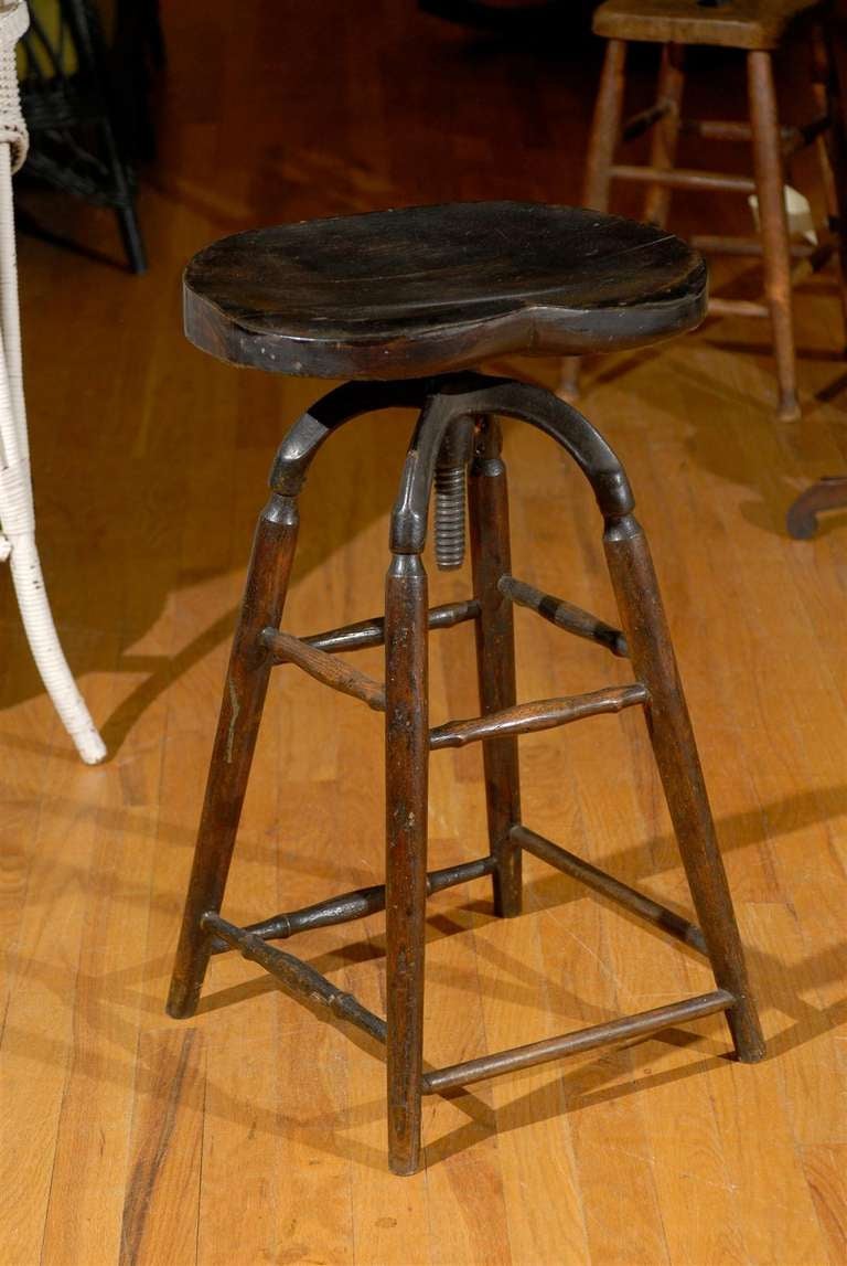 This is a lovely swivel Elm clerk stool circa 1920.  It has a nice bum seat made for comfort.  In England they call the seat shape Bum and in America they are titled Saddle stools.