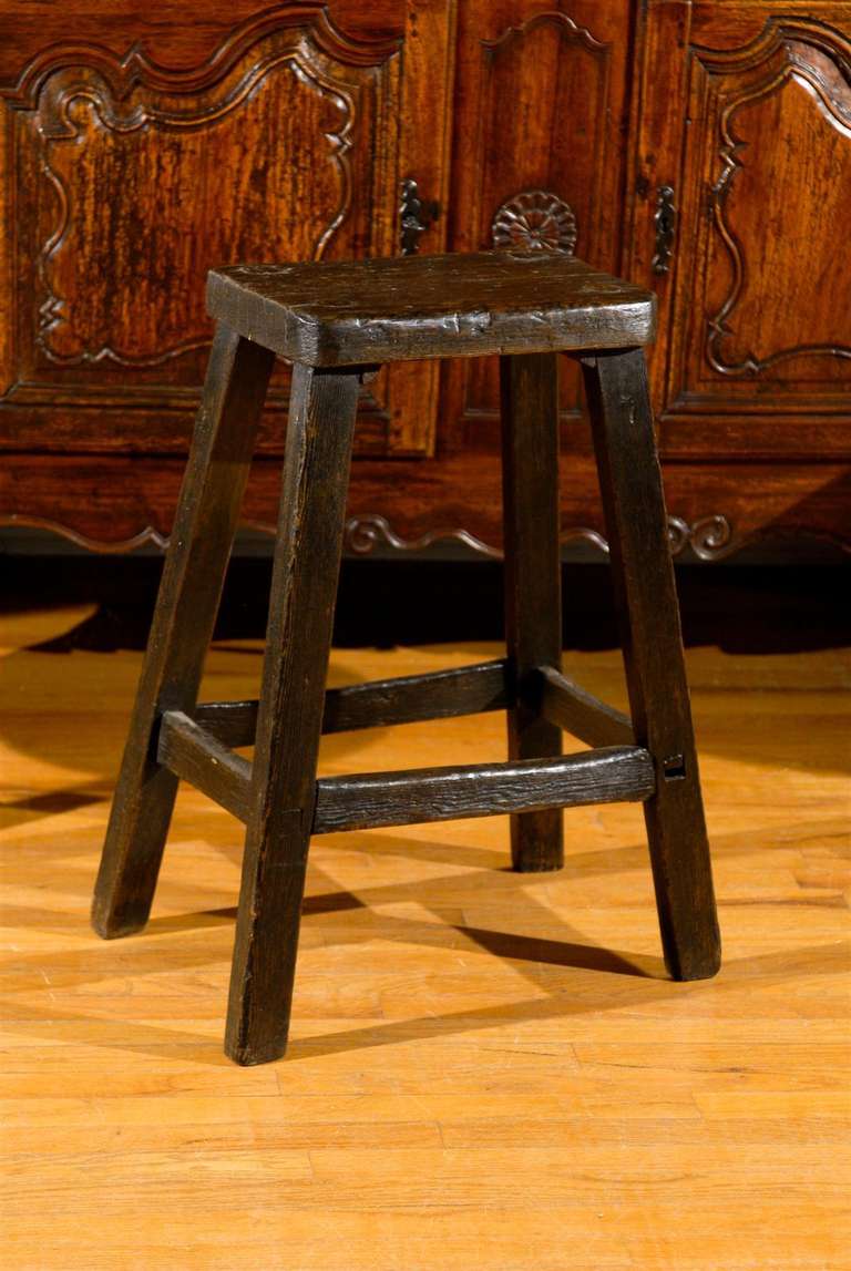 This is a great example of an English Stool.   The legs are doweled through the top.  The color is lovely and very dark.