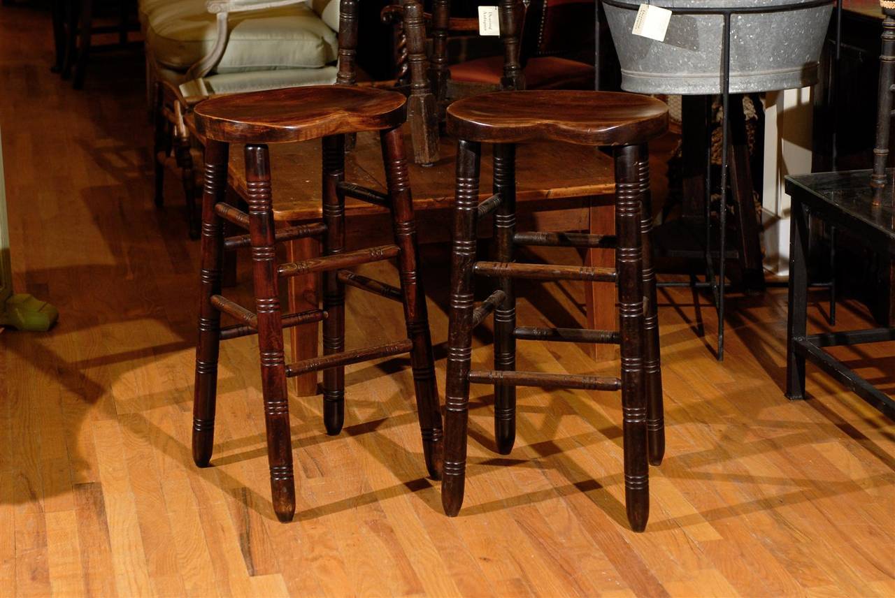 This pair of stools is in fantastic condition.  They would look wonderful around a bar in a kitchen.  The seat is shaped like a saddle and is extremely comfortable.