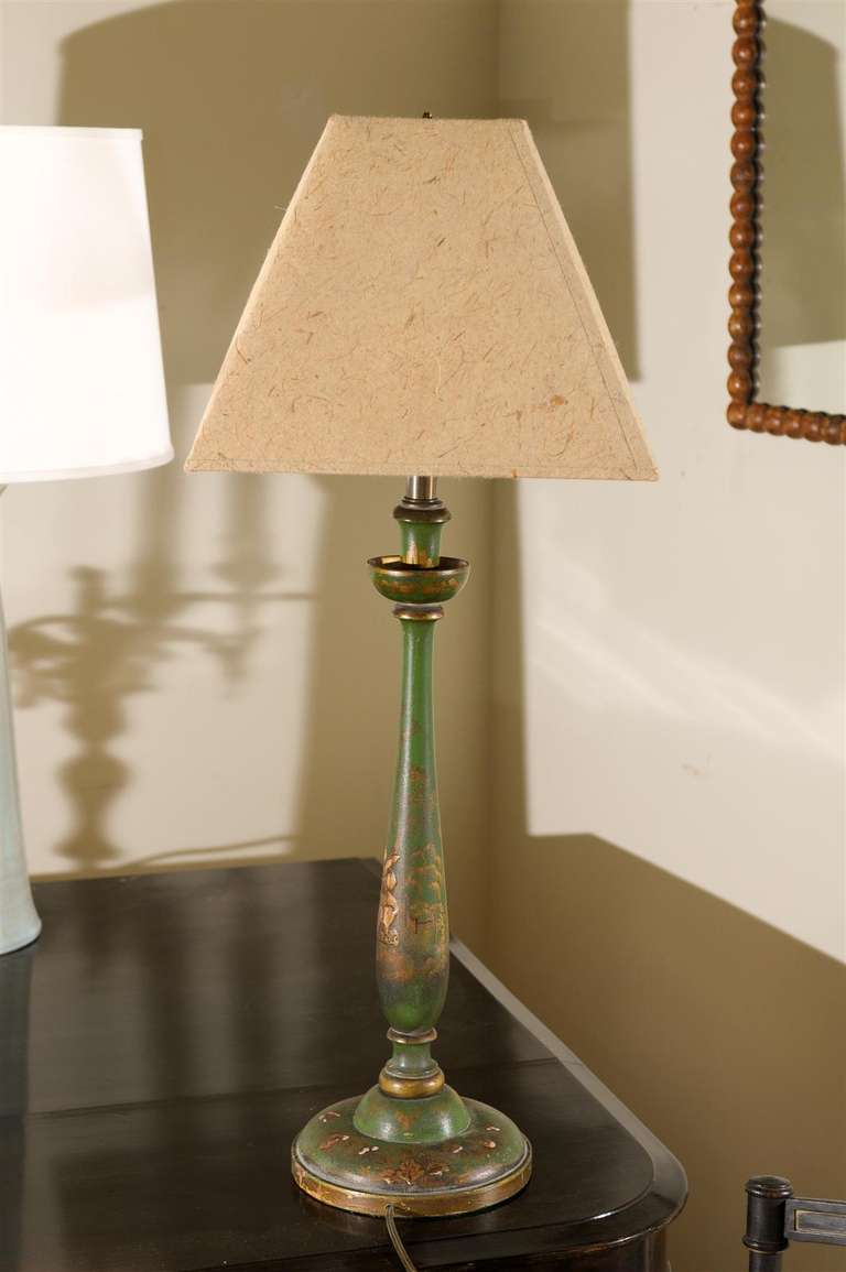 This is an English table lamp in the chinoiserie style which is the use of lacquer like materials and decorations